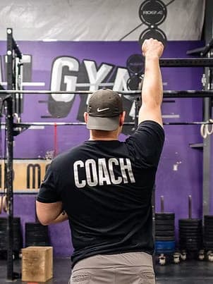 A Misfit coach from behind in a COACH shirt on the gym floor