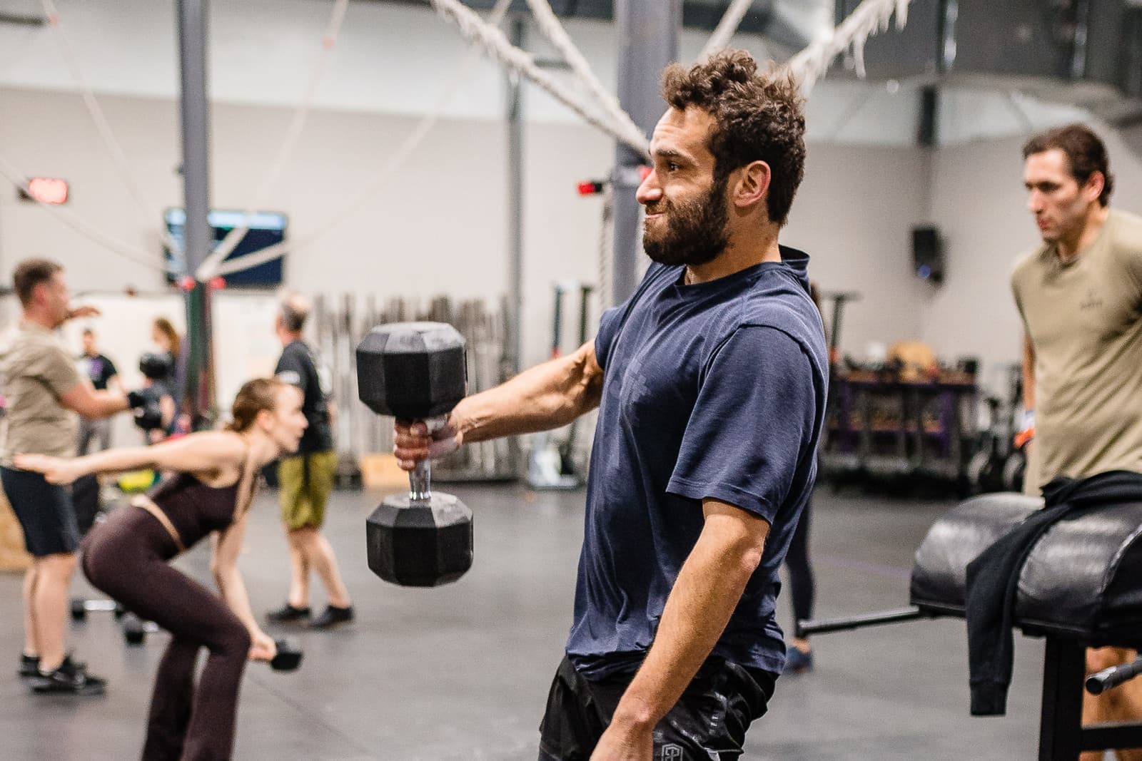 A Misfit member putting in solo work at the dumbbell rack