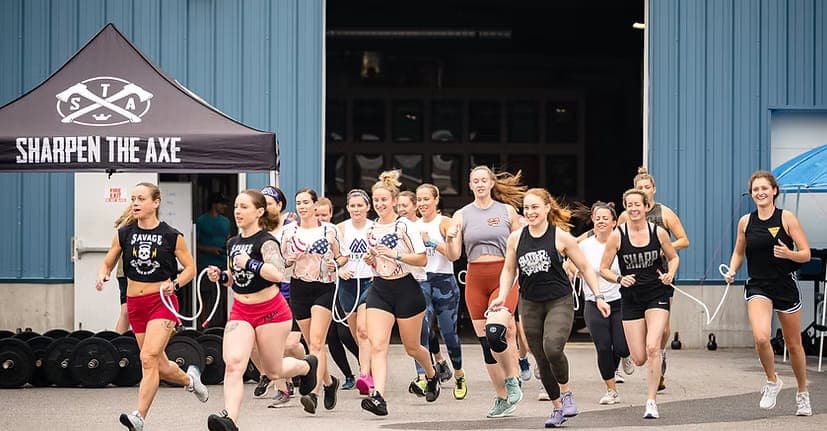 Misfit members running out of the gym bay door together at a community event